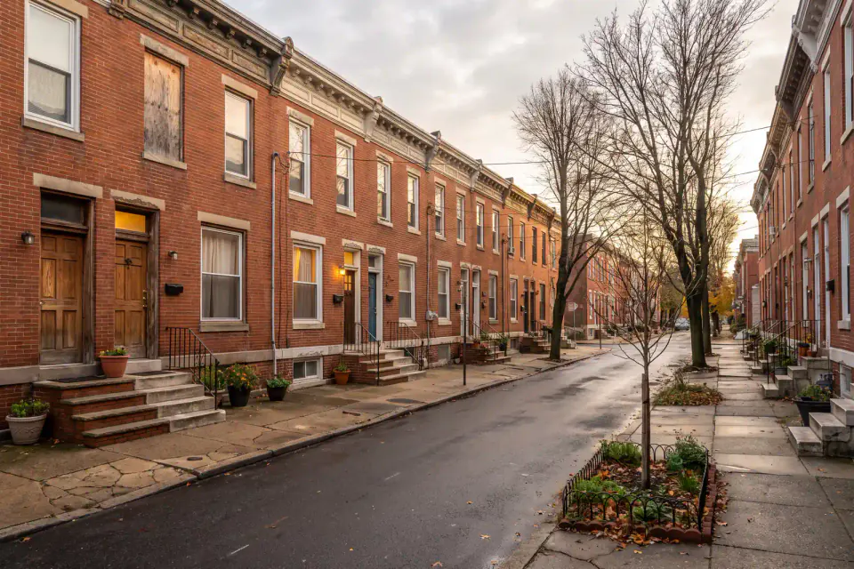 Narrow brick rowhomes lining a residential block in Kensington